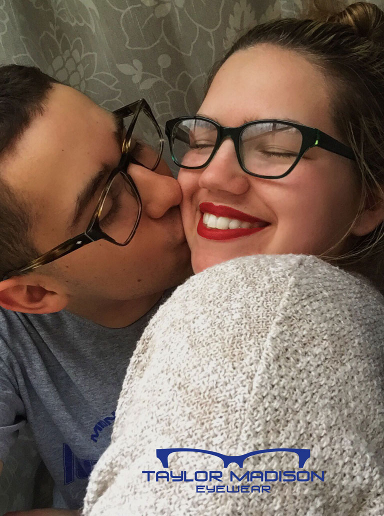 young couple kissing with glasses